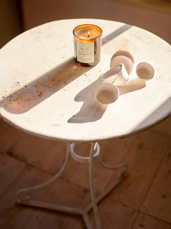 Candle on a round marble table with decorative elements