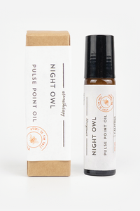 Night Owl Pulse Point Oil shown with its kraft paper packaging box and a glass roller bottle with a black cap on a clean white background.