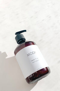Bottle of MODA hand soap on a light background