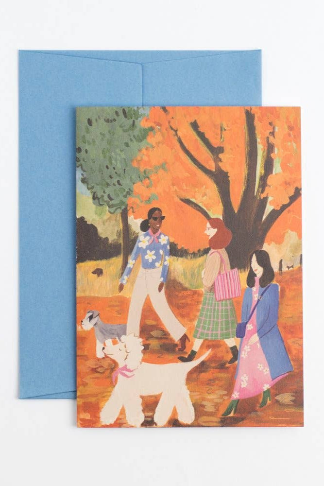 Greeting card with illustration of people walking a dog, featuring a blue envelope.
