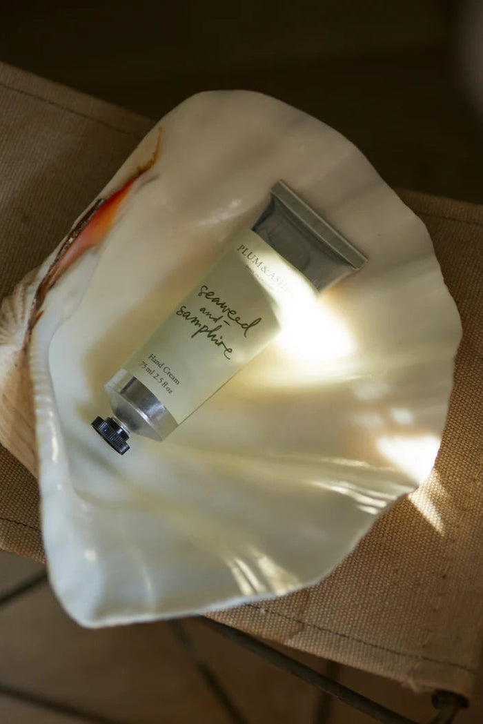 Small bottle of cream on a white cloth with a blurred background