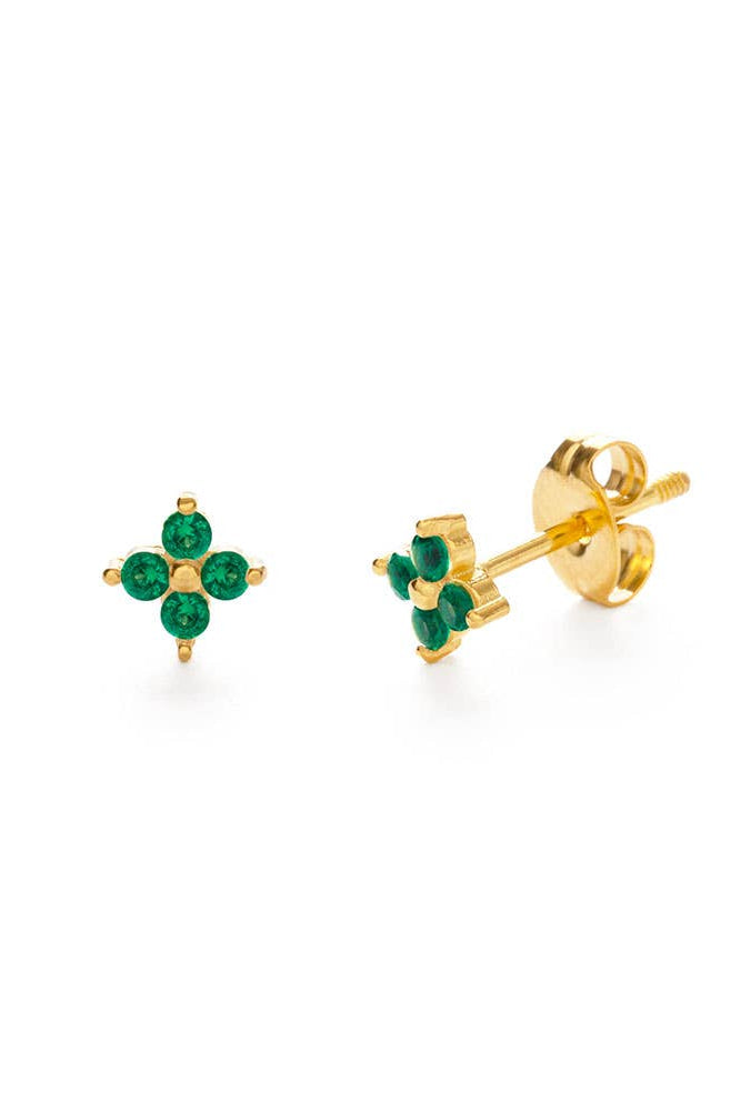 Gold earrings with green gemstones on a white background