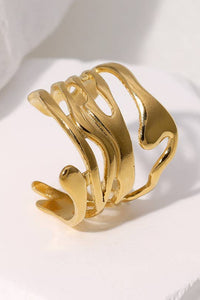 Gold bracelet on a white fabric background