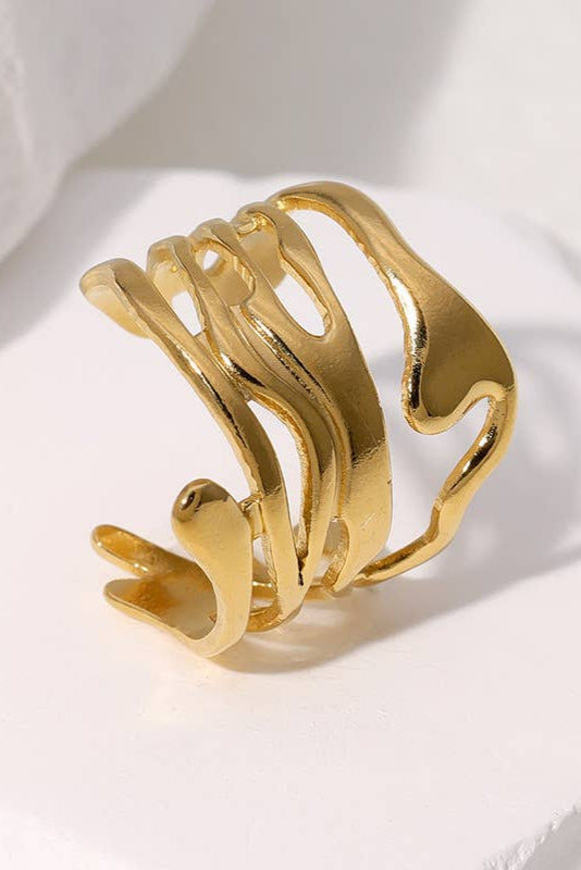 Gold bracelet on a white fabric background