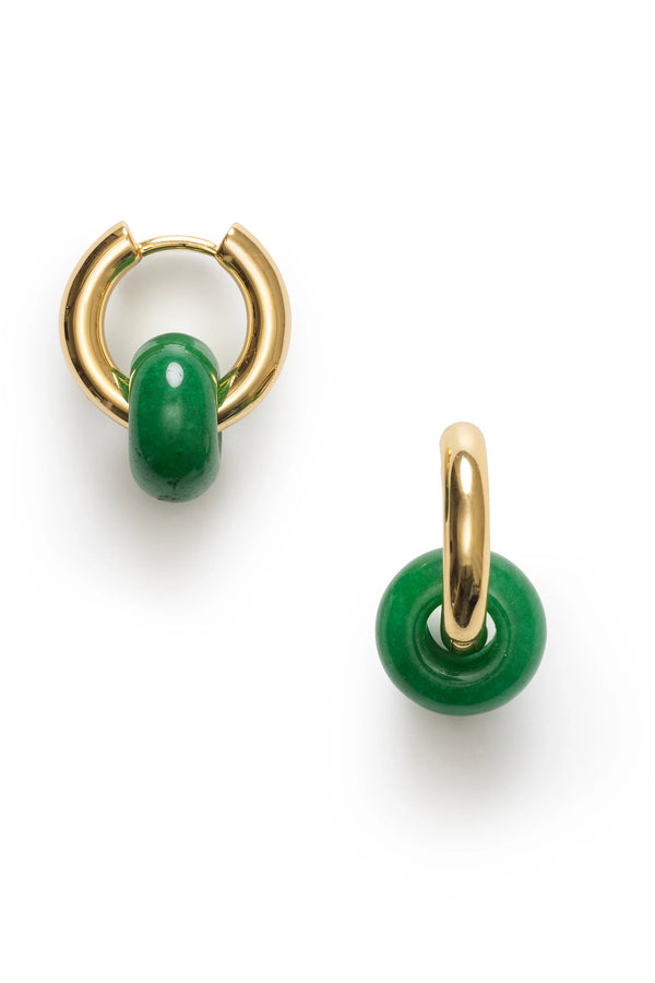 Gold hoop earrings with green beads on a white background