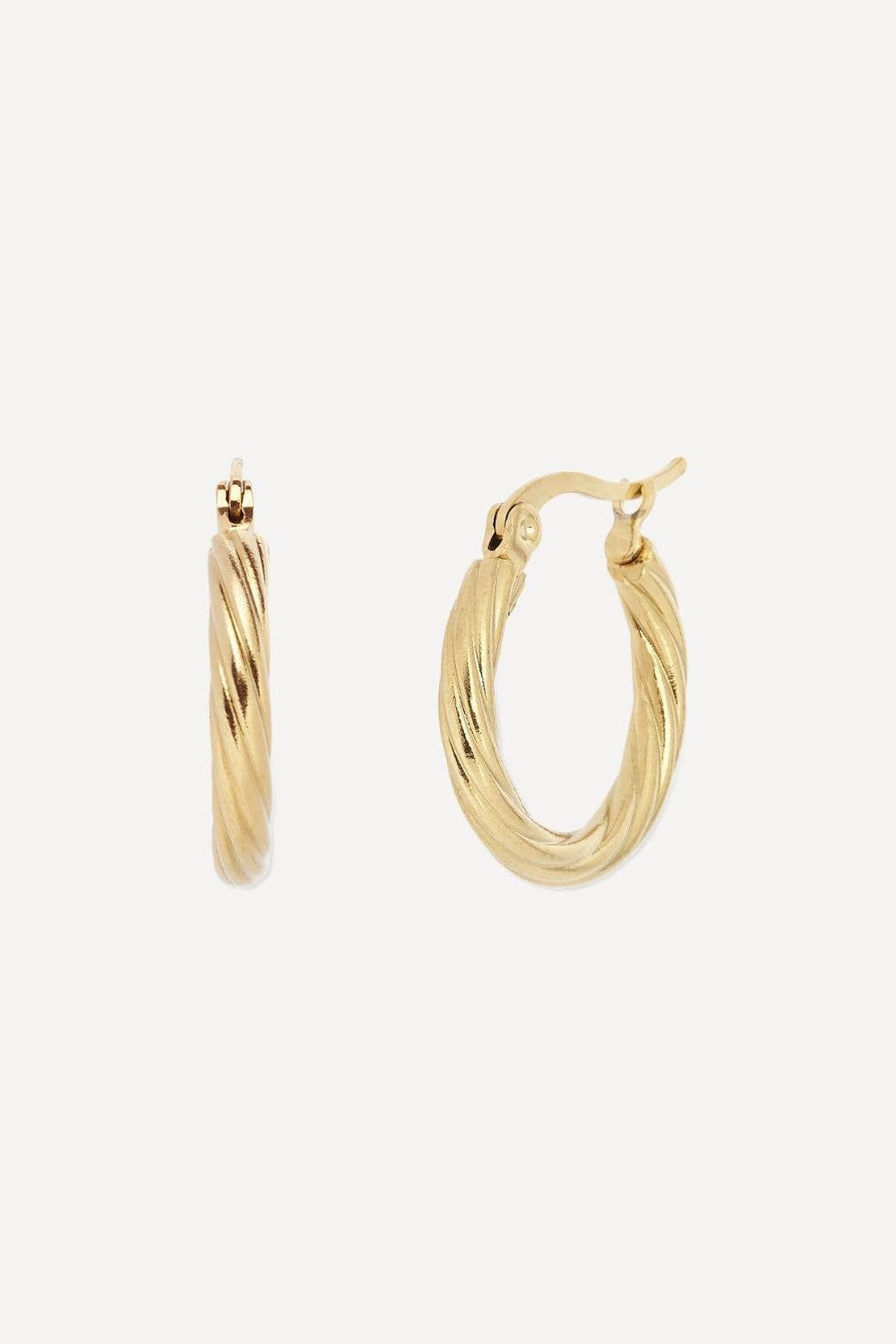 Gold hoop earrings on a light beige background
