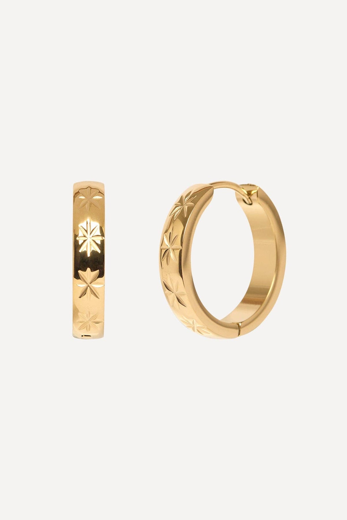Gold hoop earrings with star designs on a white background