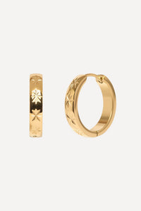 Gold hoop earrings with star designs on a white background