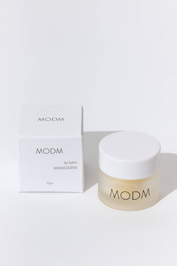 MODM lip balm and packaging on a white background