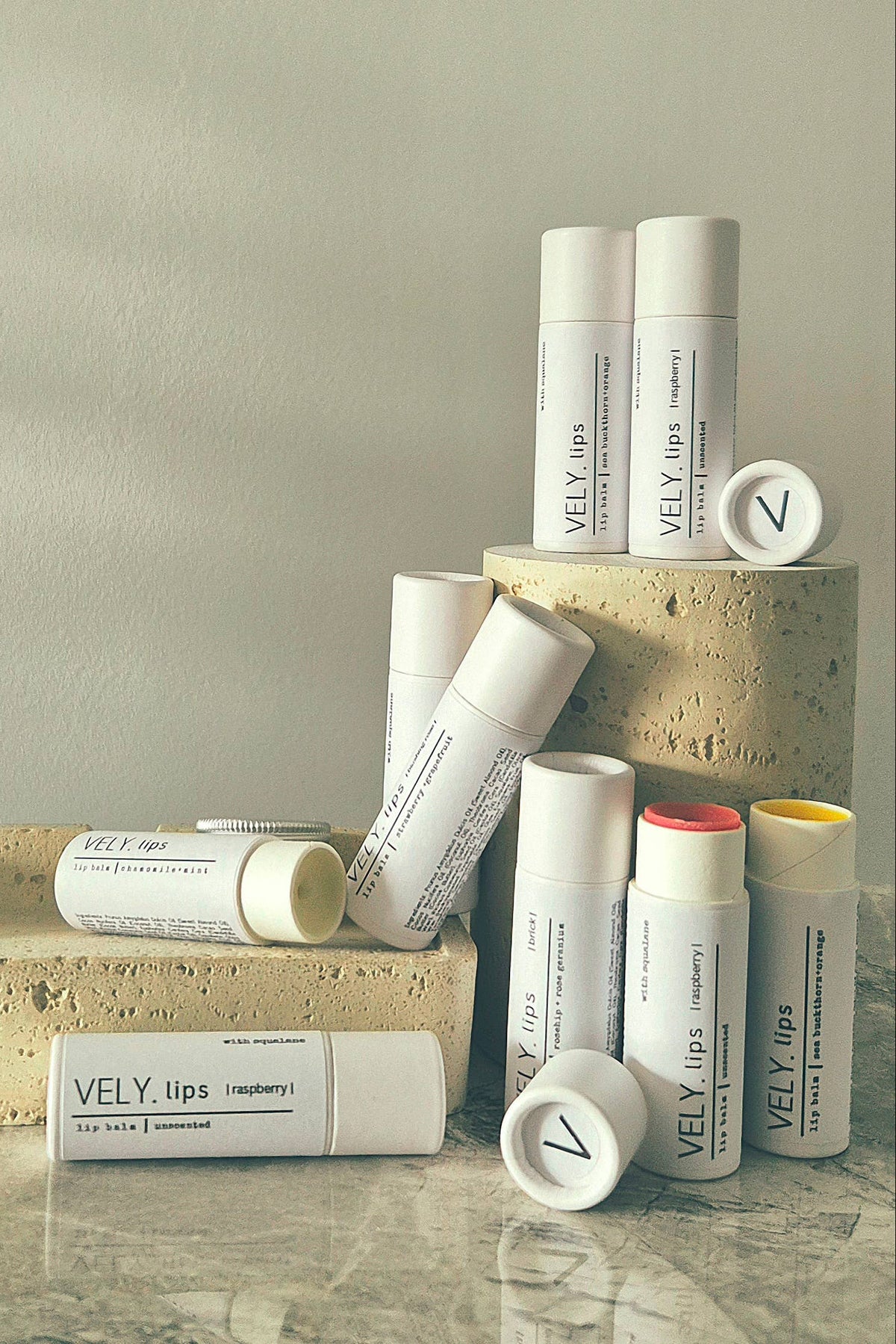 Collection of VELY Lips products on a neutral background