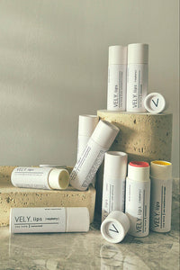 Collection of VELY Lips products on a neutral background