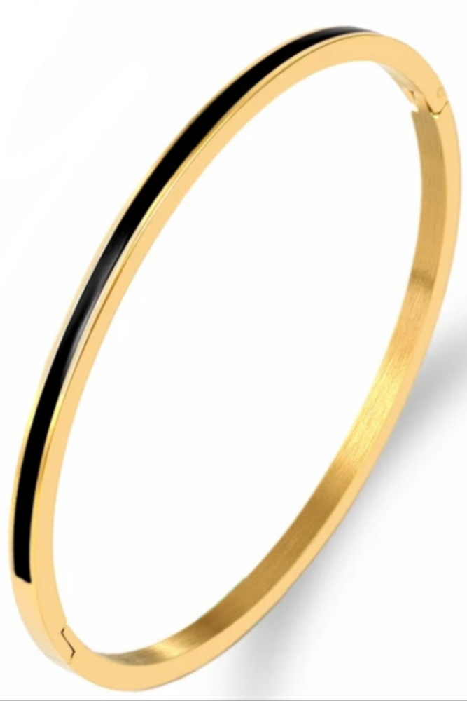 Gold bangle with black interior on a white background