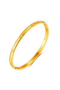 Gold bangle on a white background