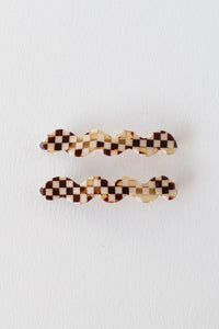 Two checkered hair clips on a white background