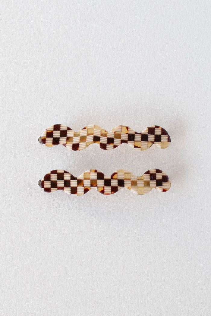 Two checkered hair clips on a white background