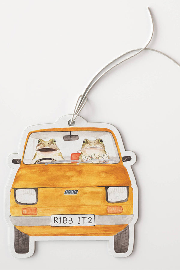 Car-shaped air freshener with frogs driving a yellow car on a white background