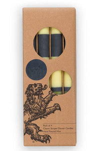 Pack of four candles in a cardboard box with a lion illustration on a white background