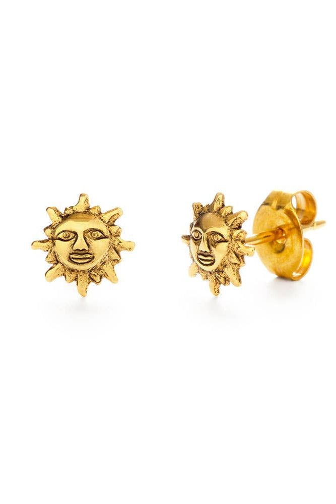 Gold sun-shaped earrings on a white background