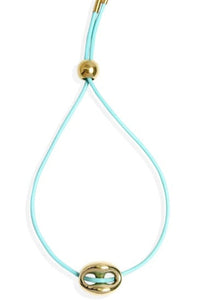 Turquoise cord bracelet with gold beads on a white background