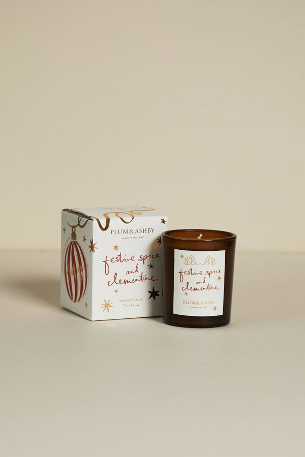 Plum & Ash candle with packaging on a beige background