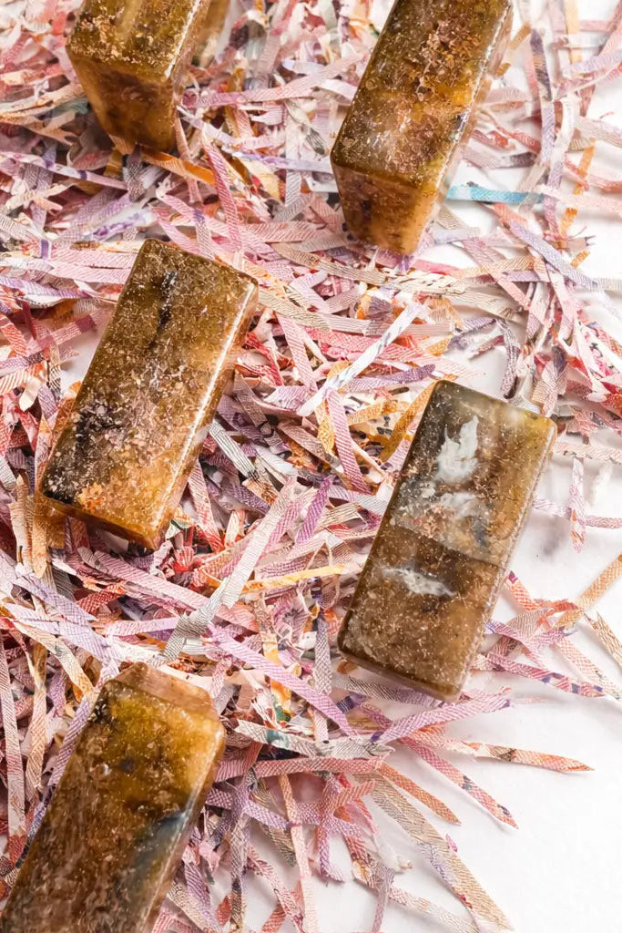Brown rectangular rings on a bed of pink and white shredded paper