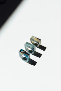Three metallic rings with a scenic background on a white surface