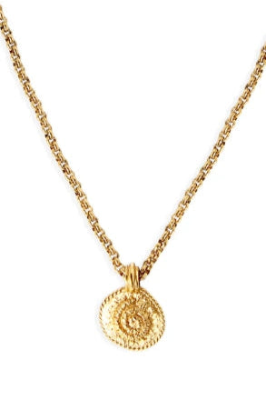 Gold necklace with a round pendant on a white background