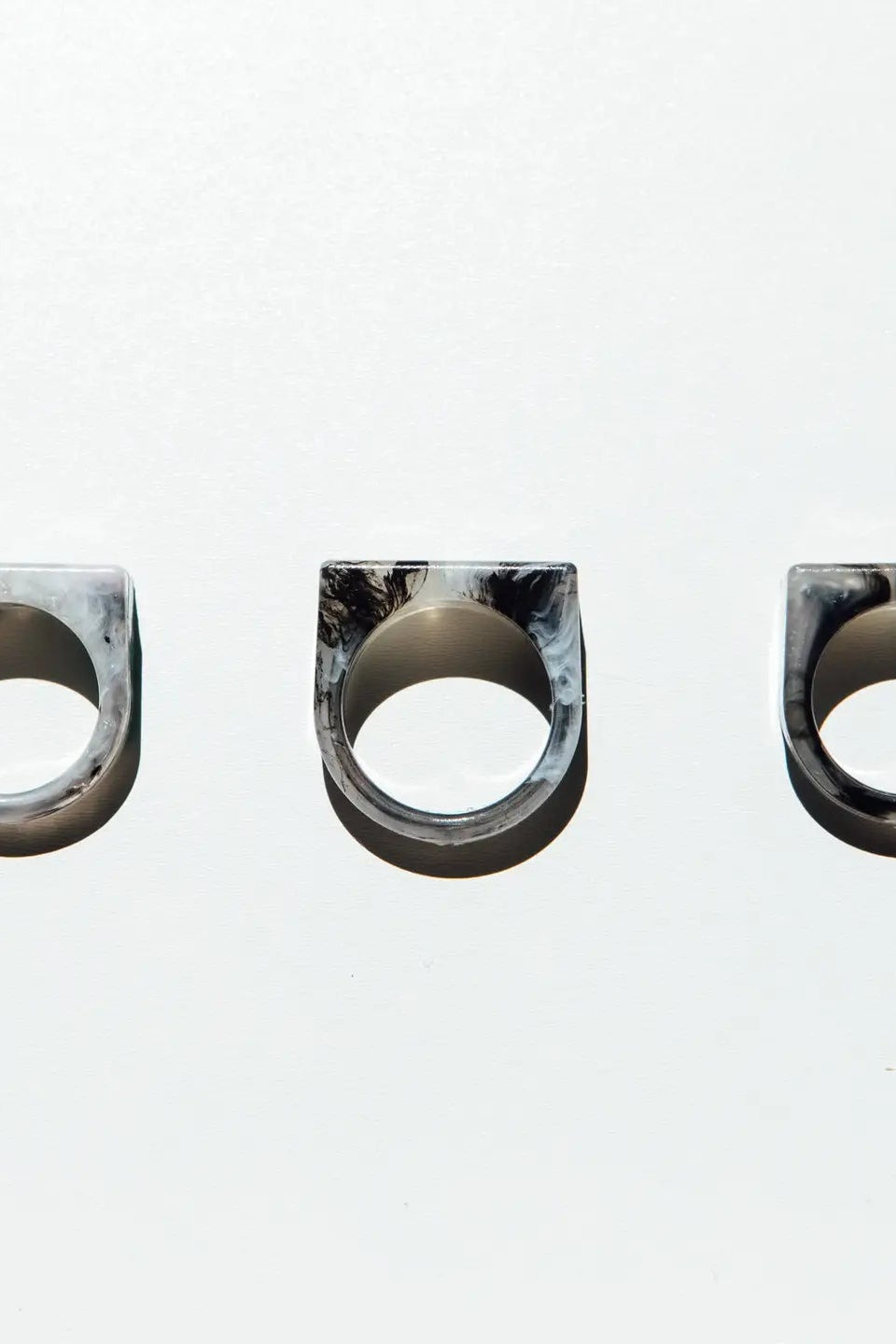 Three marbled stone rings on a white background
