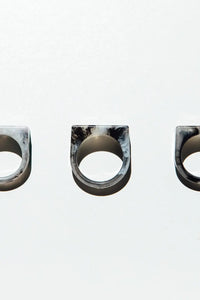 Three marbled stone rings on a white background