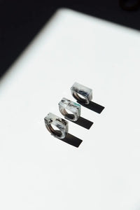 Three  rings stacked on a reflective surface