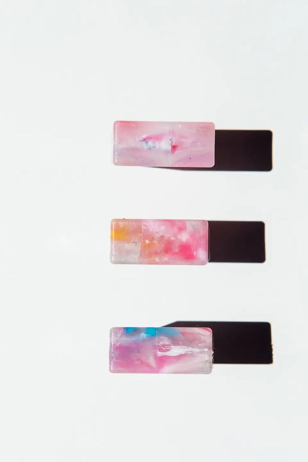Set of three rectangular rings with marble design on a white background