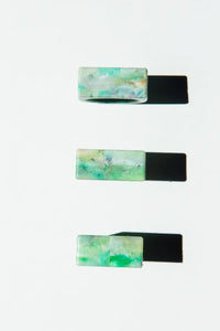 Set of three rectangular rings with a marbled green design on a white background