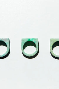 Three green rings on a light gray background
