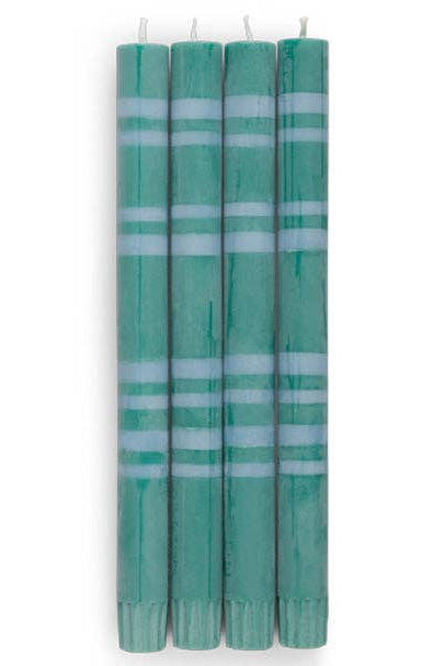 Set of five green candles with white stripes on a white background