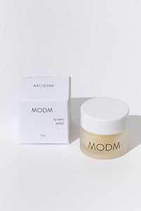 MODM lip balm and packaging on a white background