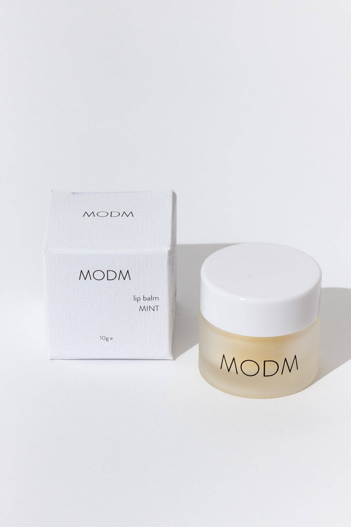 MODM lip balm and packaging on a white background