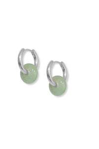 Silver hoop earrings with green round stones on a white background