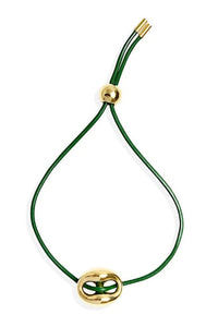 Green cord bracelet with gold clasp on a white background