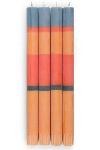 Set of four striped candles with orange, red, and gray bands on a white background