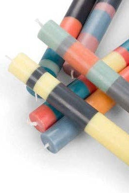 Colorful candles stacked on a white background
