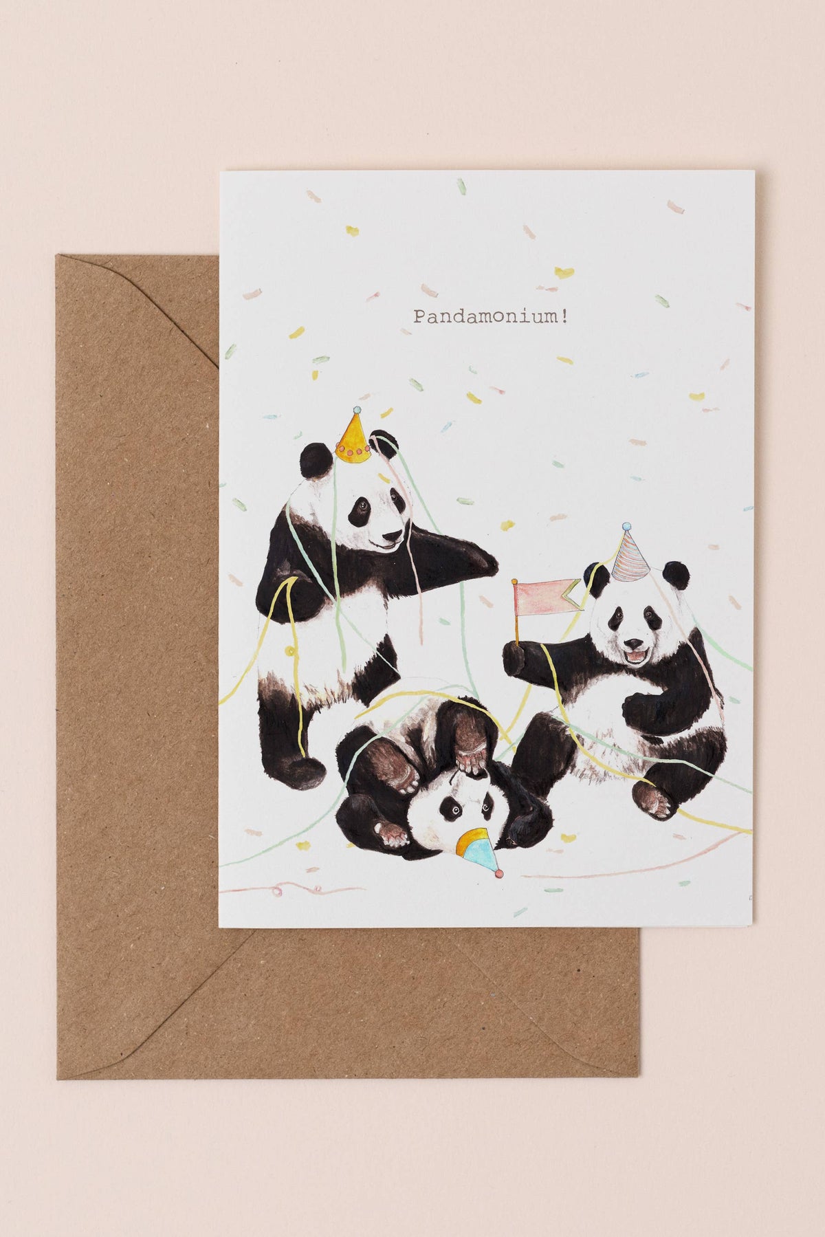 Greeting card with pandas and a brown envelope on a beige background
