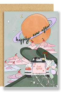 Greeting card with a cartoon car on a road, mountains, and a moon, with 'happily ever after' text.