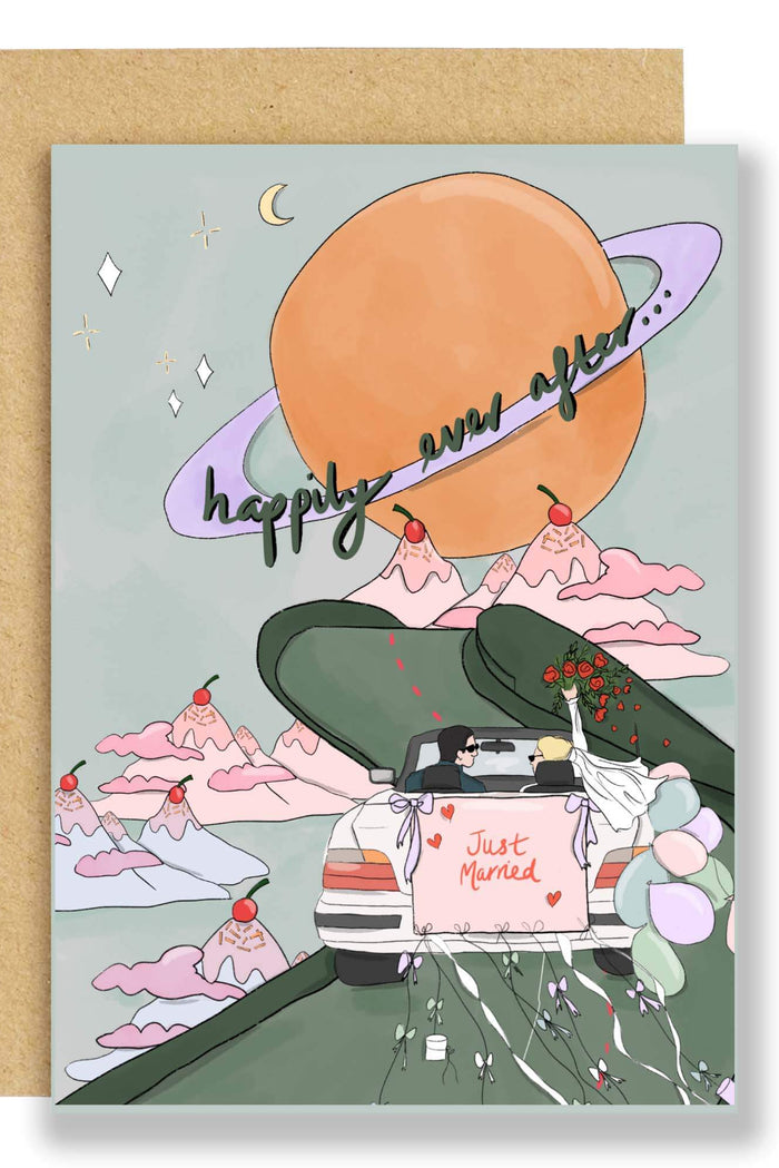 Greeting card with a cartoon car on a road, mountains, and a moon, with 'happily ever after' text.