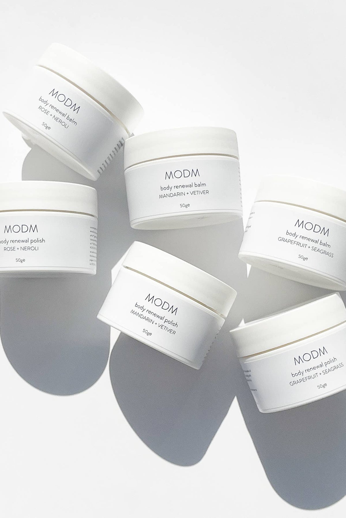MODM body treatment balm containers on a white background