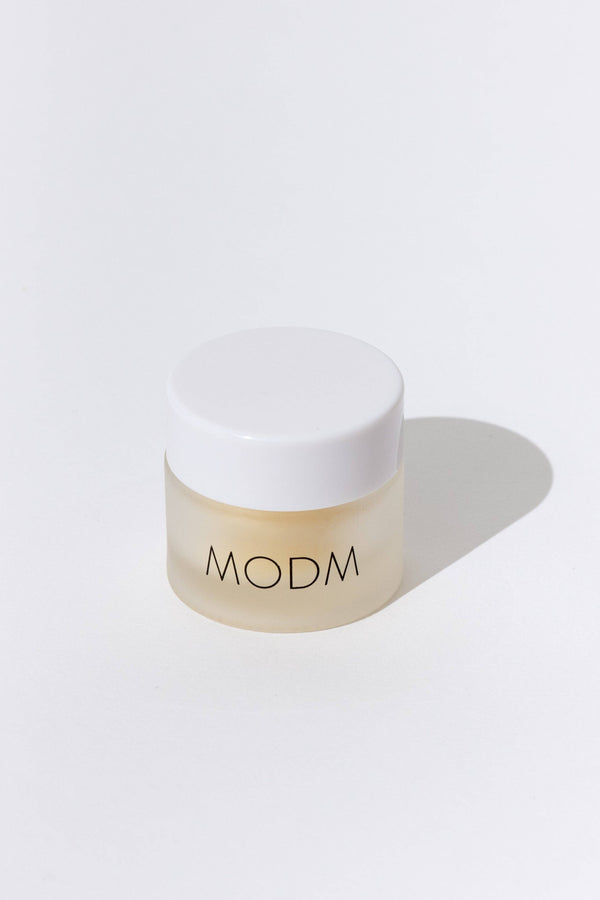 Beige jar with white lid on a light gray background