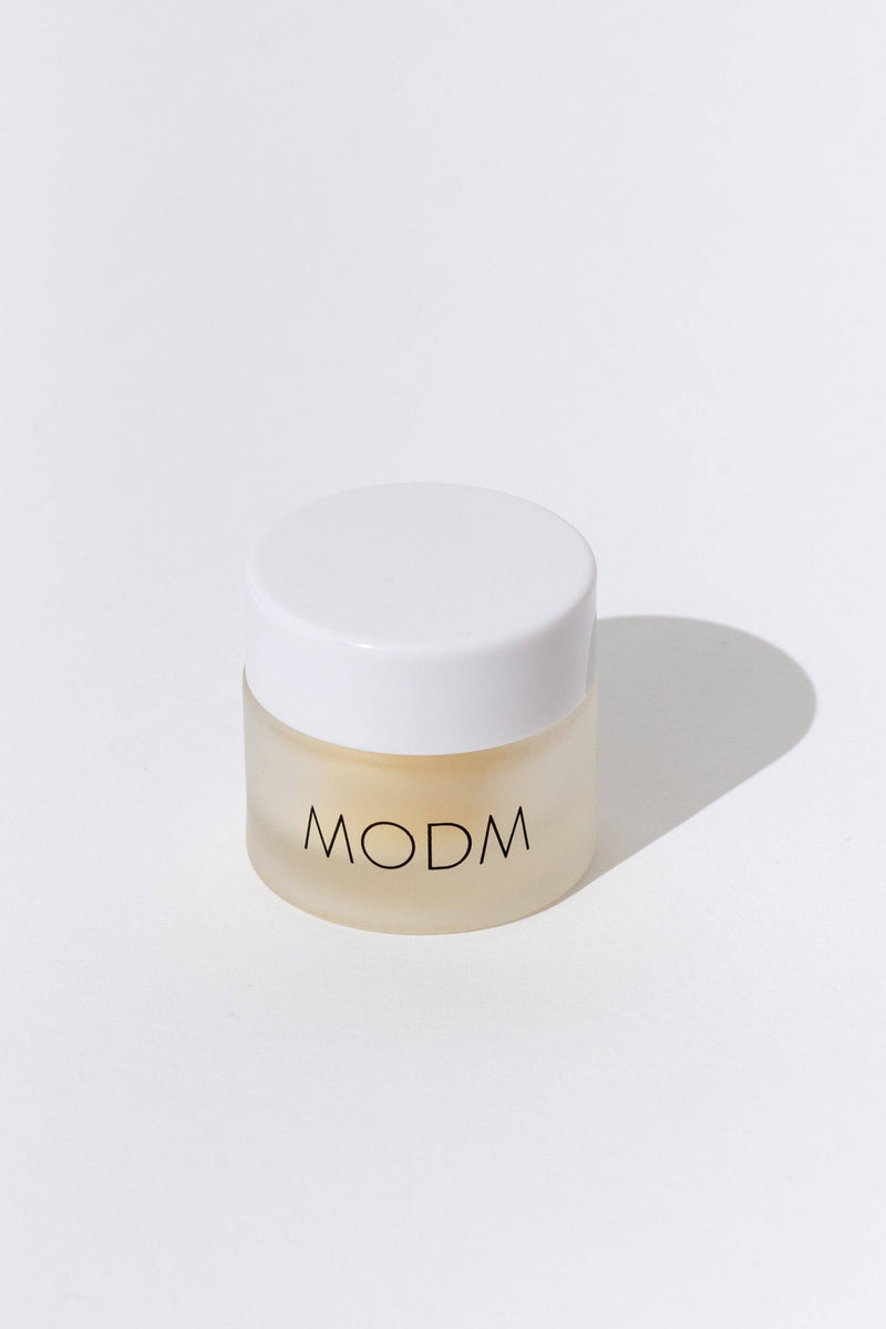 Beige jar with white lid on a light gray background