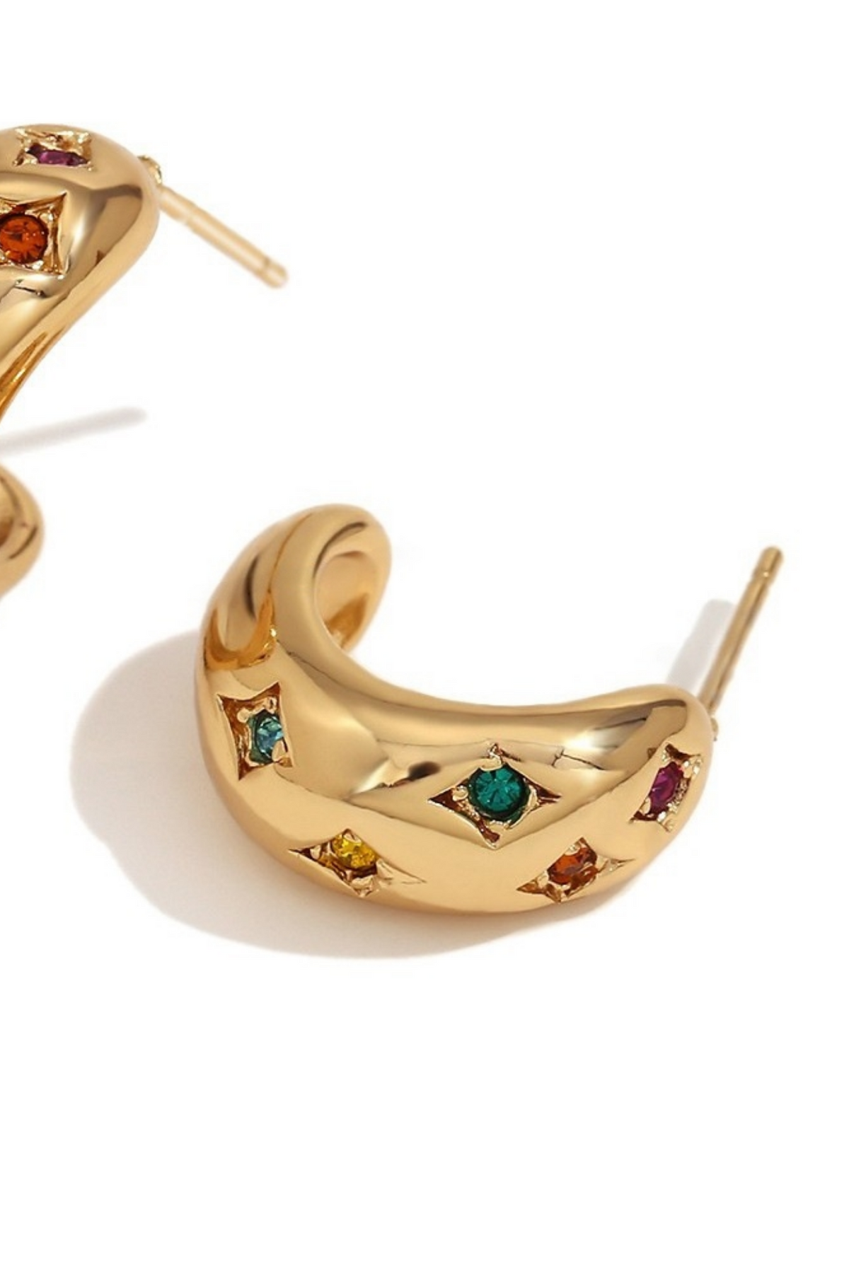 A pair of gold crescent-shaped hoop earrings with small, colorful gemstone accents in various colors, displayed on a clean white background.