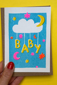 Colorful baby shower card with clouds, stars, and the word 'Baby' on a yellow background.