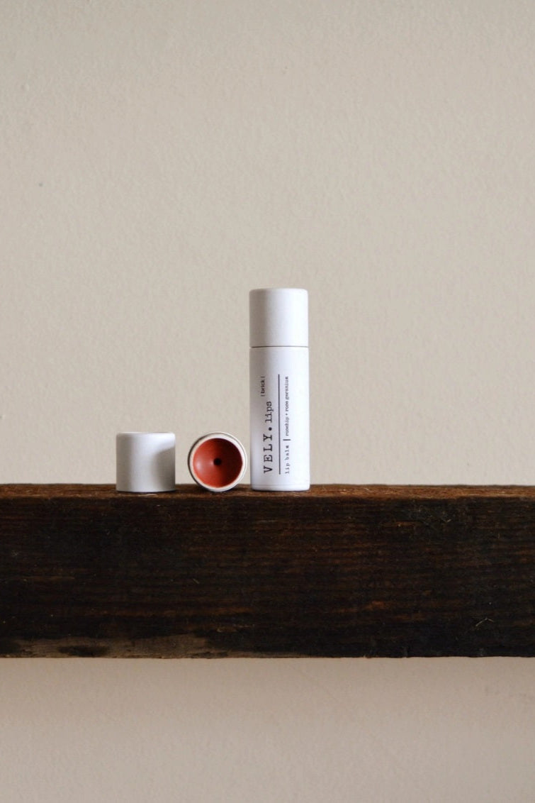 Three cylindrical containers on a wooden surface with a neutral background