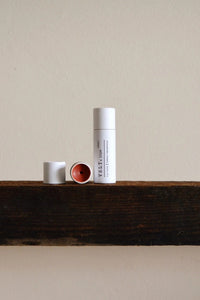 Three cylindrical containers on a wooden surface with a neutral background